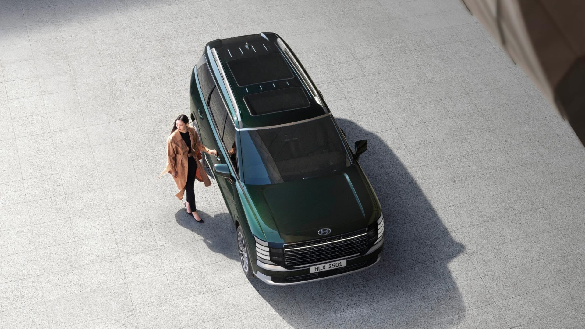 Side-front view of orange Grandi10 with lakeside view at night